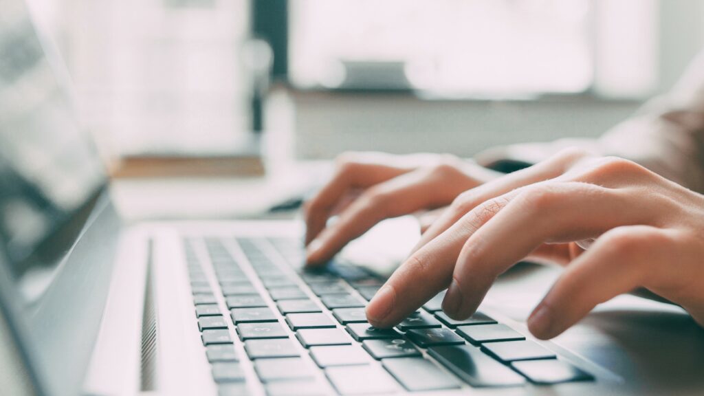 Close shot of person working on computer.