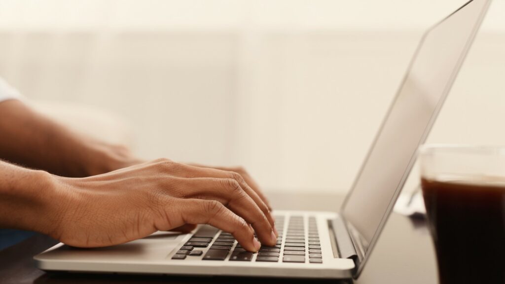 Close shot of person working on computer.