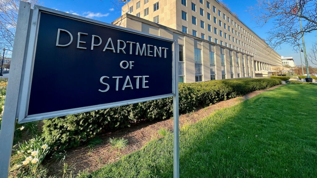 An office building with a Department of State sign in front.