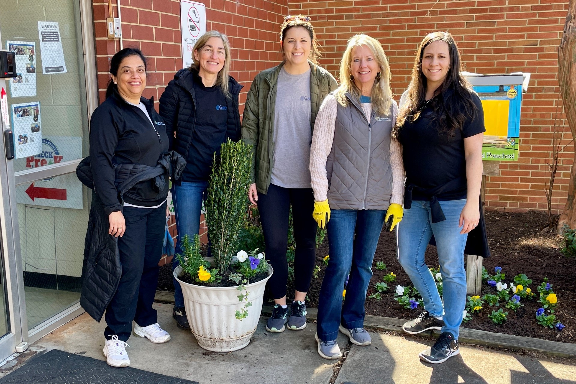 Members of Garfinkel Immigration Law Firm outside the Charlotte Bilingual Preschool. 