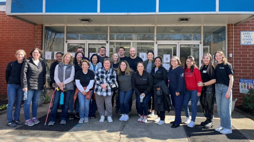 Members of Garfinkel Immigration Law Firm and the Charlotte Bilingual Preschool outside the school's main entrance