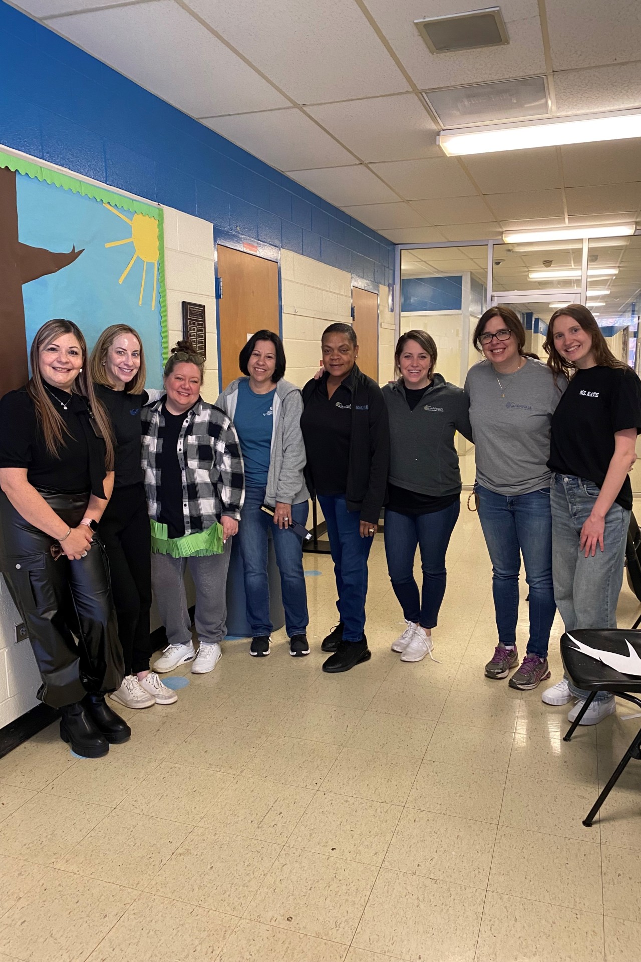 Members of the Charlotte Bilingual Preschool staff and Garfinkel Immigration Law Firm at the school. 