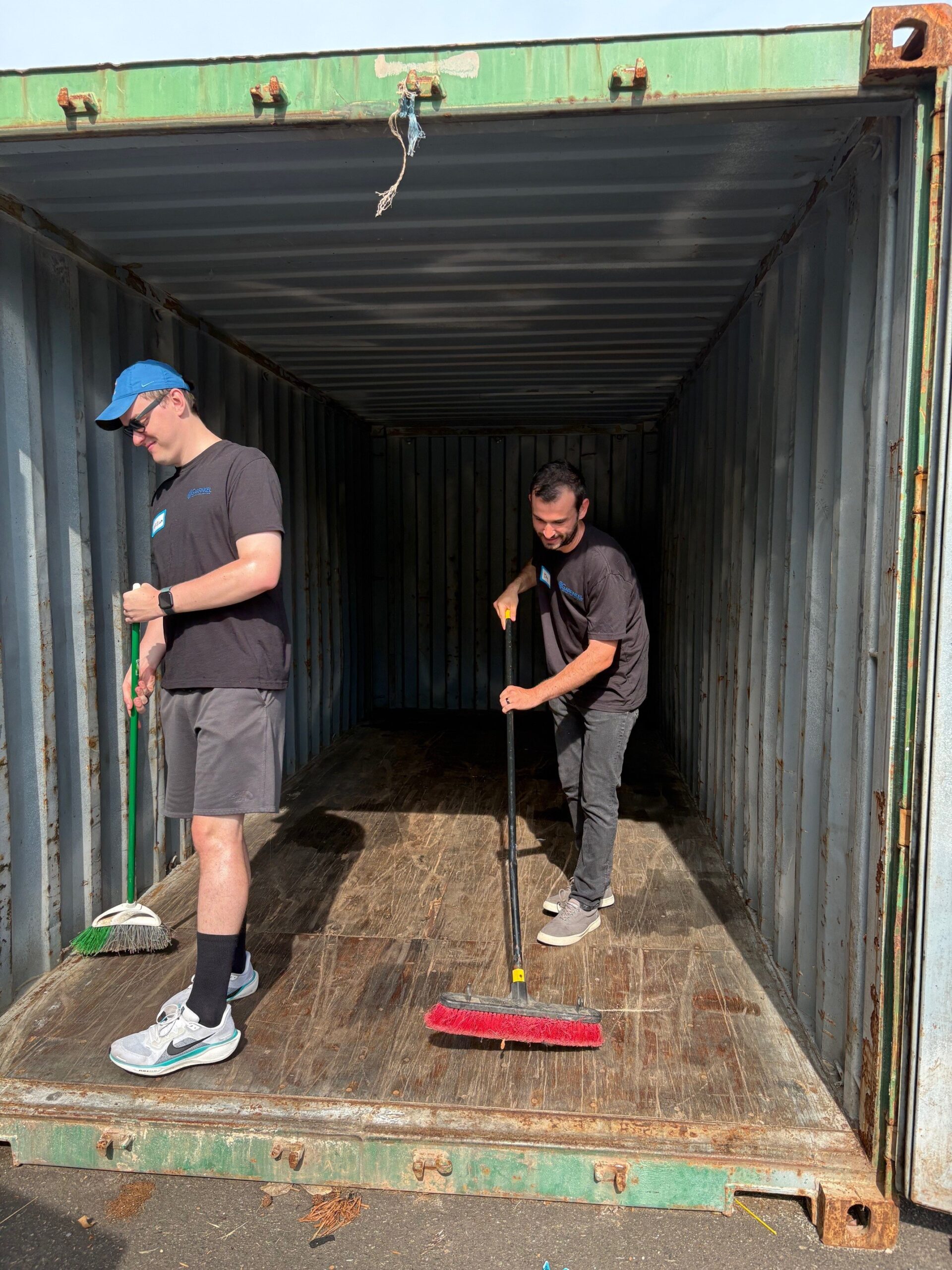 Members of Garfinkel Immigration sweep a shed.