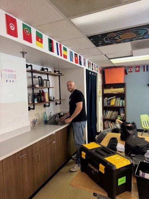 Garfinkel Immigration staff members cleaning classroom at ourBRIDGE for KIDS.